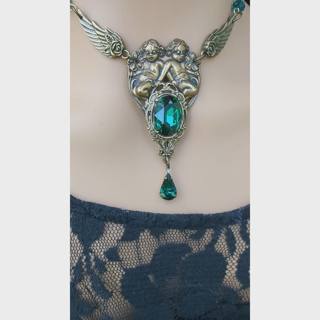Video of Romantic brass jewelry set featuring cherub pendant necklace and coordinating earrings with green Swarovski accents