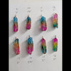 Natural Rainbow quartz crystal tree of life wire wrapped pendants arranged in rows on a white background