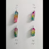 Natural Rainbow quartz crystal tree of life wire wrapped pendants arranged in rows on a white background