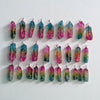 Natural Rainbow quartz crystal tree of life wire wrapped pendants arranged in rows on a white background