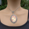 Necklace Pendant with decorative cream colored holiday bells on red background and silver frame on model