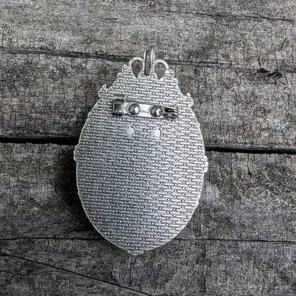 back side of cameo pendant displaying brooch pin