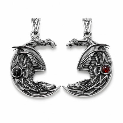 Double sided silver dragon pendant on crescent moon design with red and black gemstones on a white background.  Dragon lover jewelry