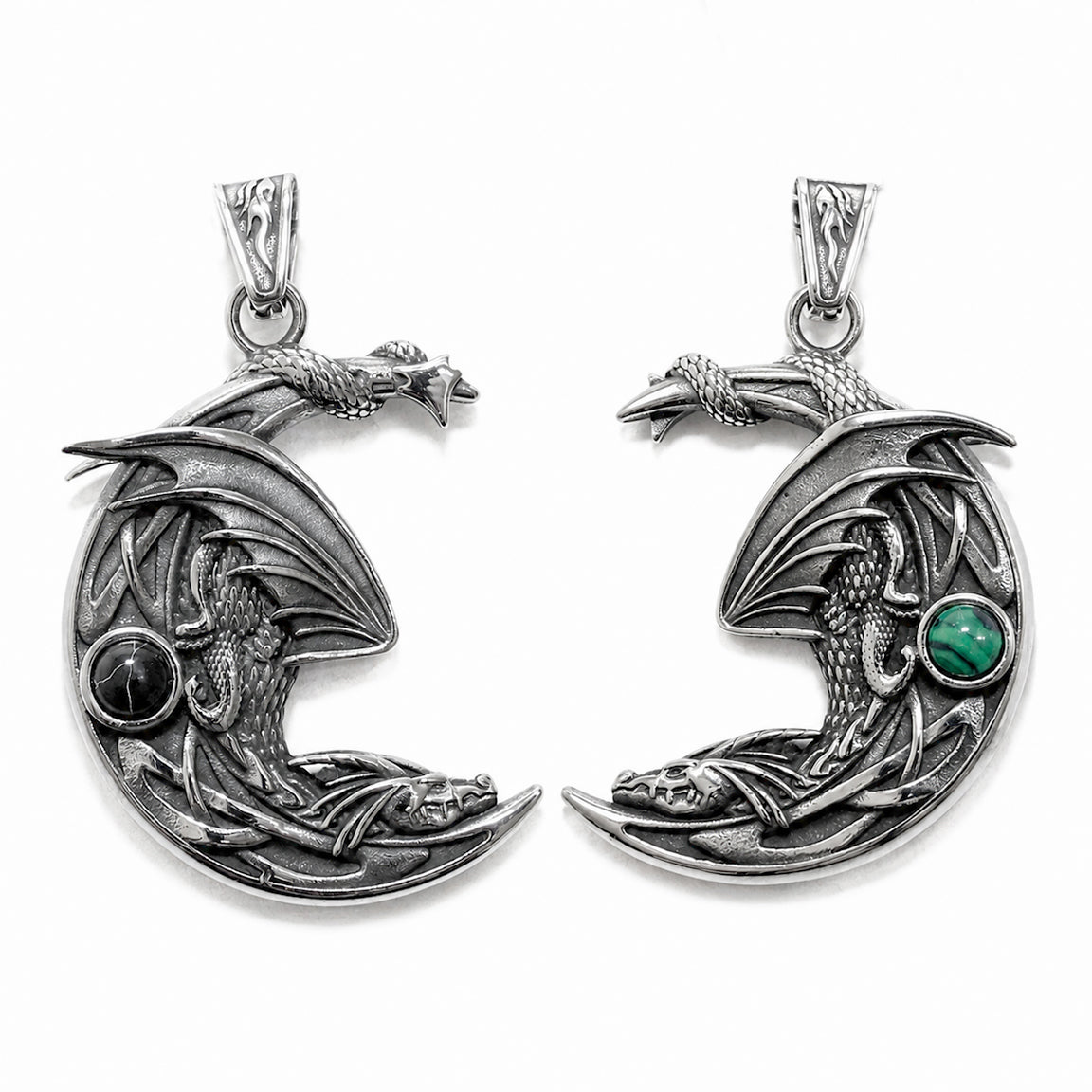Double sided silver dragon pendant in the shape of a crescent moon with green and back gemstones on a white background.  Dragon lover fantasy jewelry