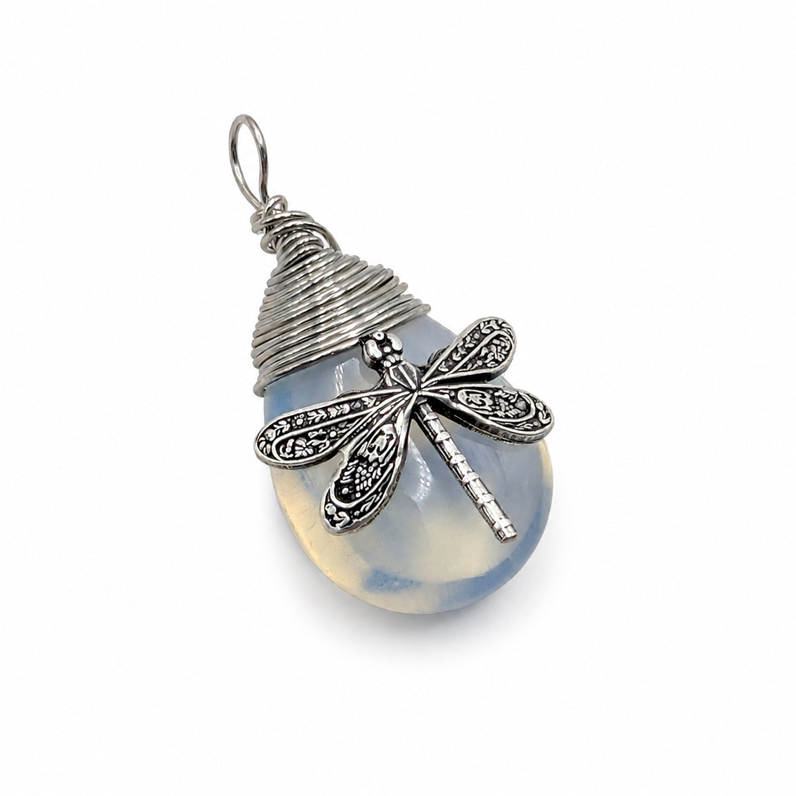 A silver dragonfly pendant necklace resting on a plain white background. The pendant features a blue synthetic opal stone  with a detailed dragonfly.