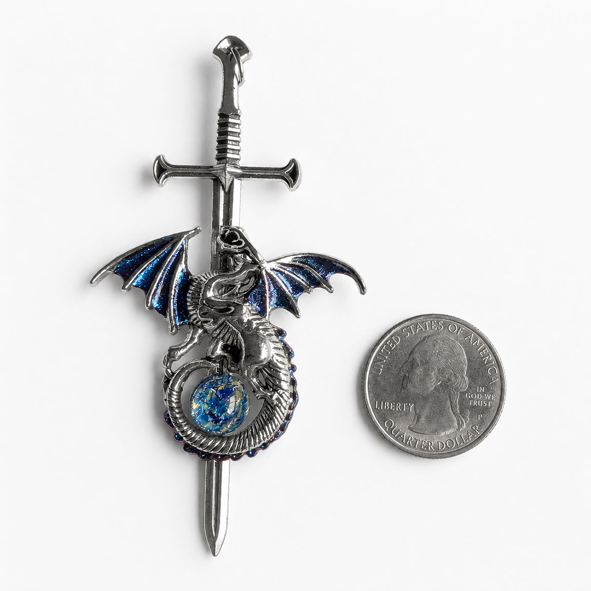 Decorative sword with a silver dragon pendant and blue opal on a white background next to a quarter for scale.  Fantasy dragon lover jewelry.