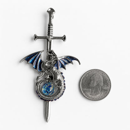 Decorative sword with a silver dragon pendant and blue opal on a white background next to a quarter for scale.  Fantasy dragon lover jewelry.