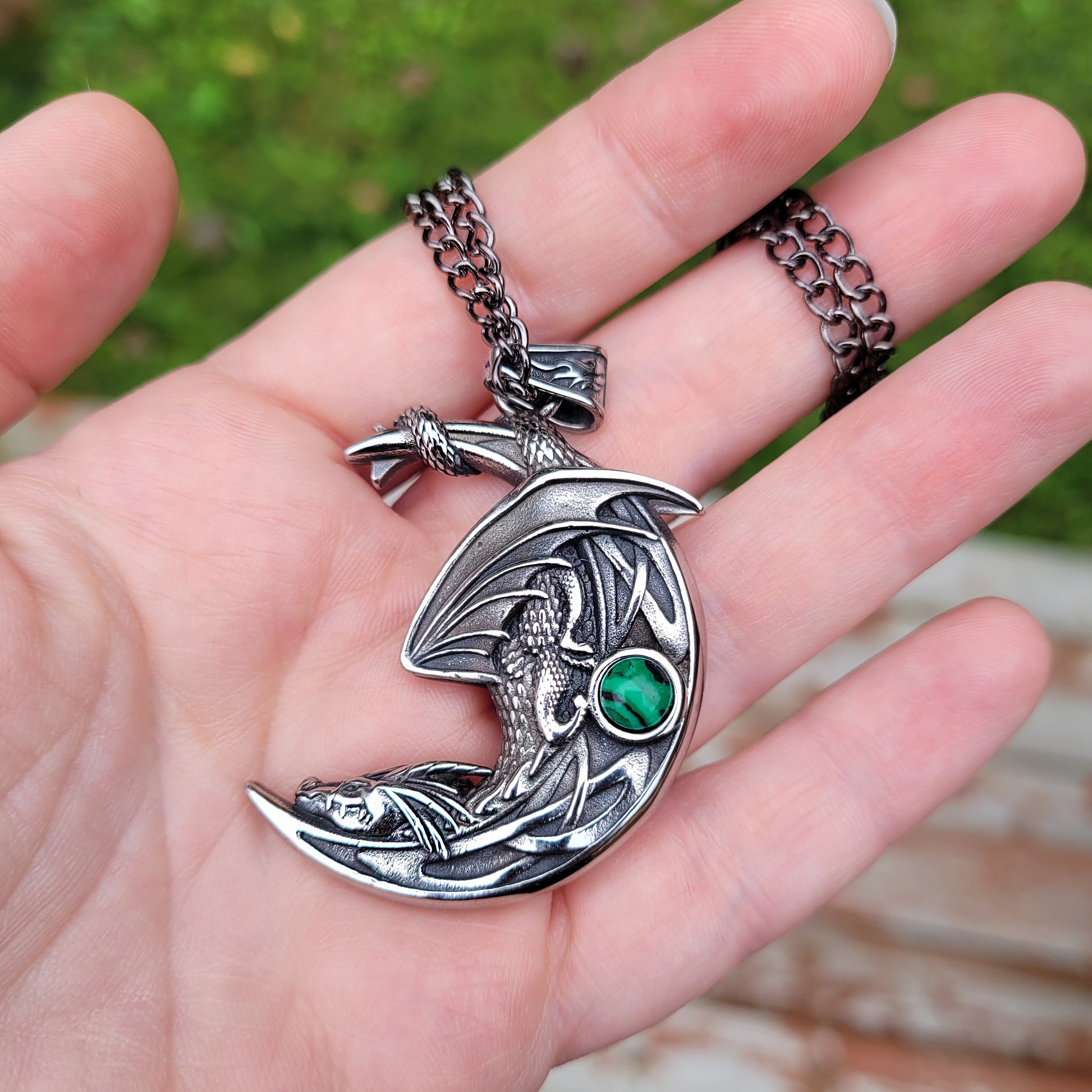 sleeping dragon on moon pendant necklace with malachite stone held in hand. dragon lover jewelry, fantasy jewelry