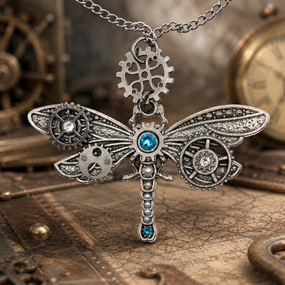 Steampunk dragonfly pendant necklace in silver-tone metal with intricate gear details and blue gemstone accents, shown hanging against a vintage-themed background.