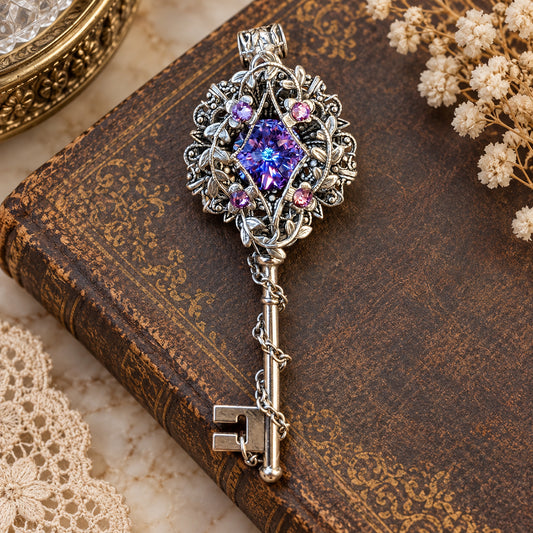 Sterling silver fantasy key necklace with a Swarovski Vitrail Light crystal in purple, pink, and blue tones, displayed on a vintage embossed book background.