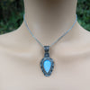 Necklace with a blue moonstone pendant on a model