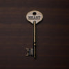 Vintage key with 'HEART' engraved on a dark brown background