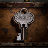 Vintage key with 'SECRET' engraved on a rusty surface