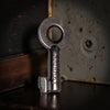 Vintage-style key with 'Journey' engraving on a dark background