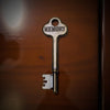 Vintage key with 'MEMORY' engraved on a wooden surface