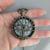 Vintage-style pocket watch held in a hand against a neutral background