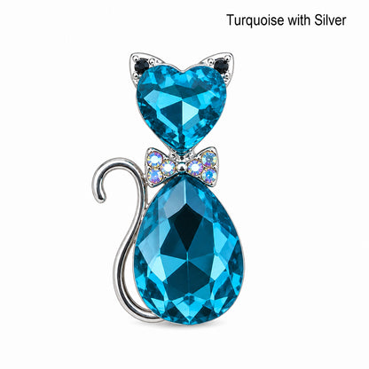 Turquoise crystal cat-shaped pendant with silver accents on a white background