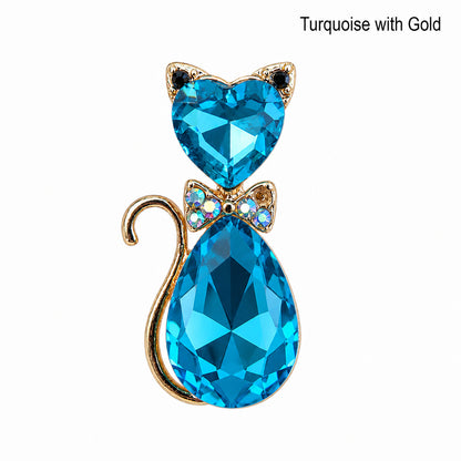 Turquoise crystal cat-shaped pendant with gold accents on a white background.  Cat lover jewelry.