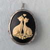 cream and black cat lovers cameo necklace on silver locket.