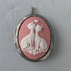 Pink and white cat lovers cameo necklace on silver locket.