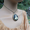 cream and black cat lovers cameo locket necklace, side view on model