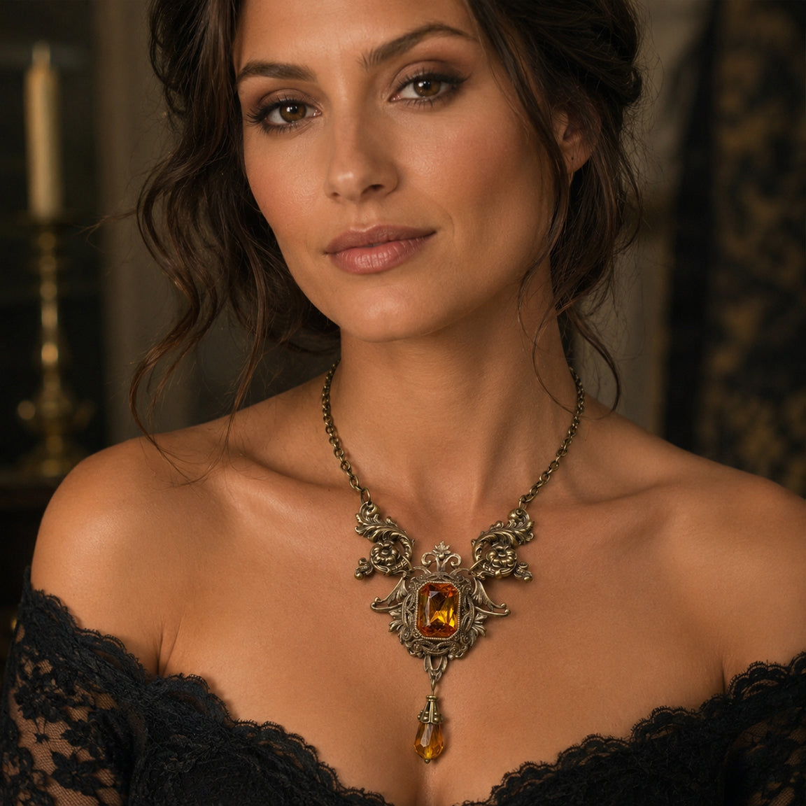 Woman wearing a vintage styled Victorian necklace with an orange crystal and mactshing drop pedant in a dimly lit room