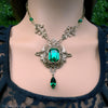 Ornate necklace with green gemstones on a woman