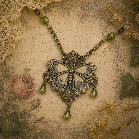Brass Vintage Cottagecore Butterfly necklace with olivine gemstones on antique background