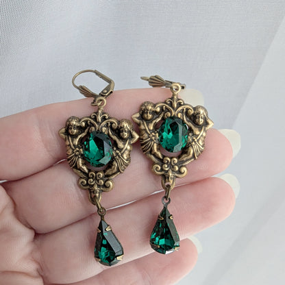 Matching brass earrings with emerald Swarovski crystals and floral scrollwork design