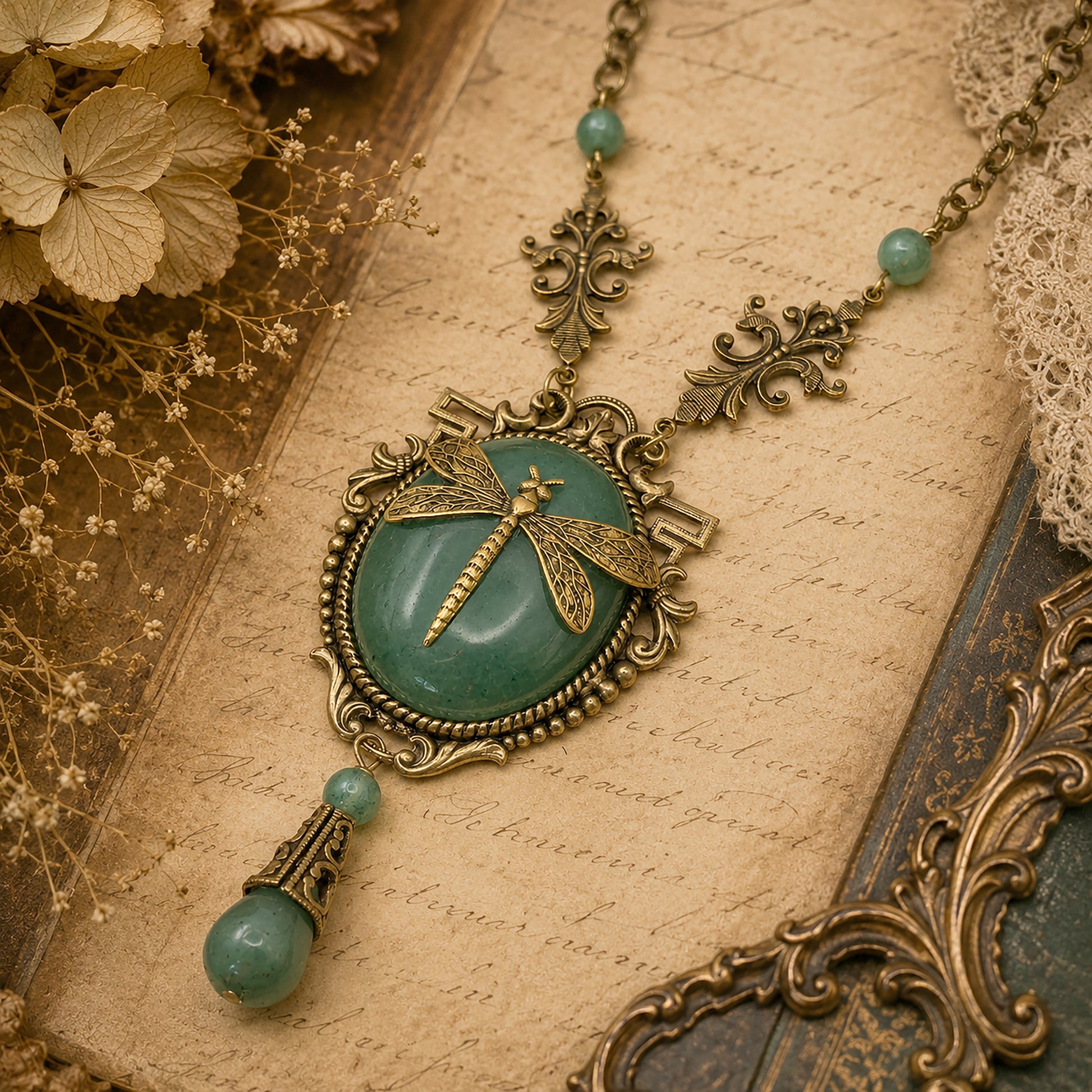 Vintage-style necklace with dragonfly pendant on an old document