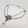 Necklace with floral clasp and pearl beads on a white background