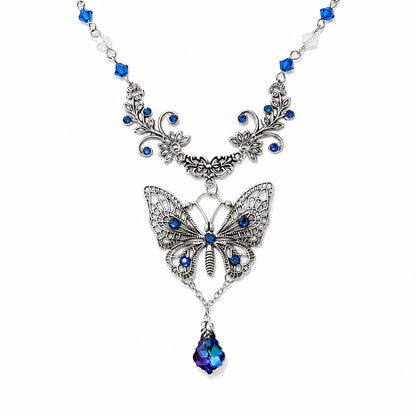 Butterfly necklace with blue gemstones on a white background