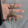Gothic Emerald Swarovski Crystal Crescent Moon pendant necklace held in hand