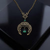 Vintage Gothic Emerald Swarovski Crystal Crescent Moon celestial pendant Necklace on black surface