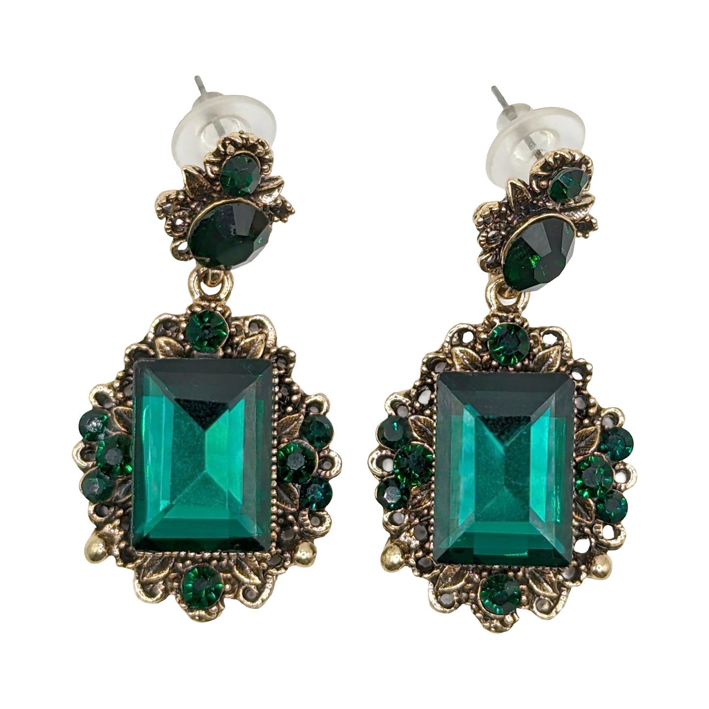 Vintage emerald green crystal earrings with a white background
