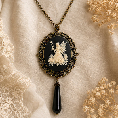 Vintage-style necklace with a fairy cameo pendant on a textured fabric background