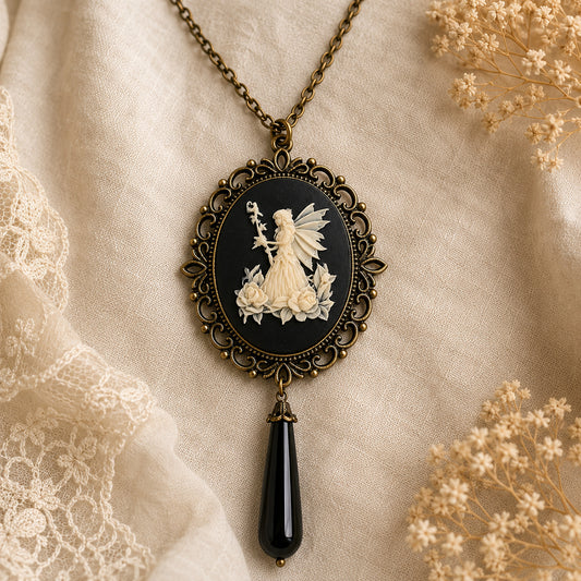 Vintage-style necklace with a fairy cameo pendant on a textured fabric background