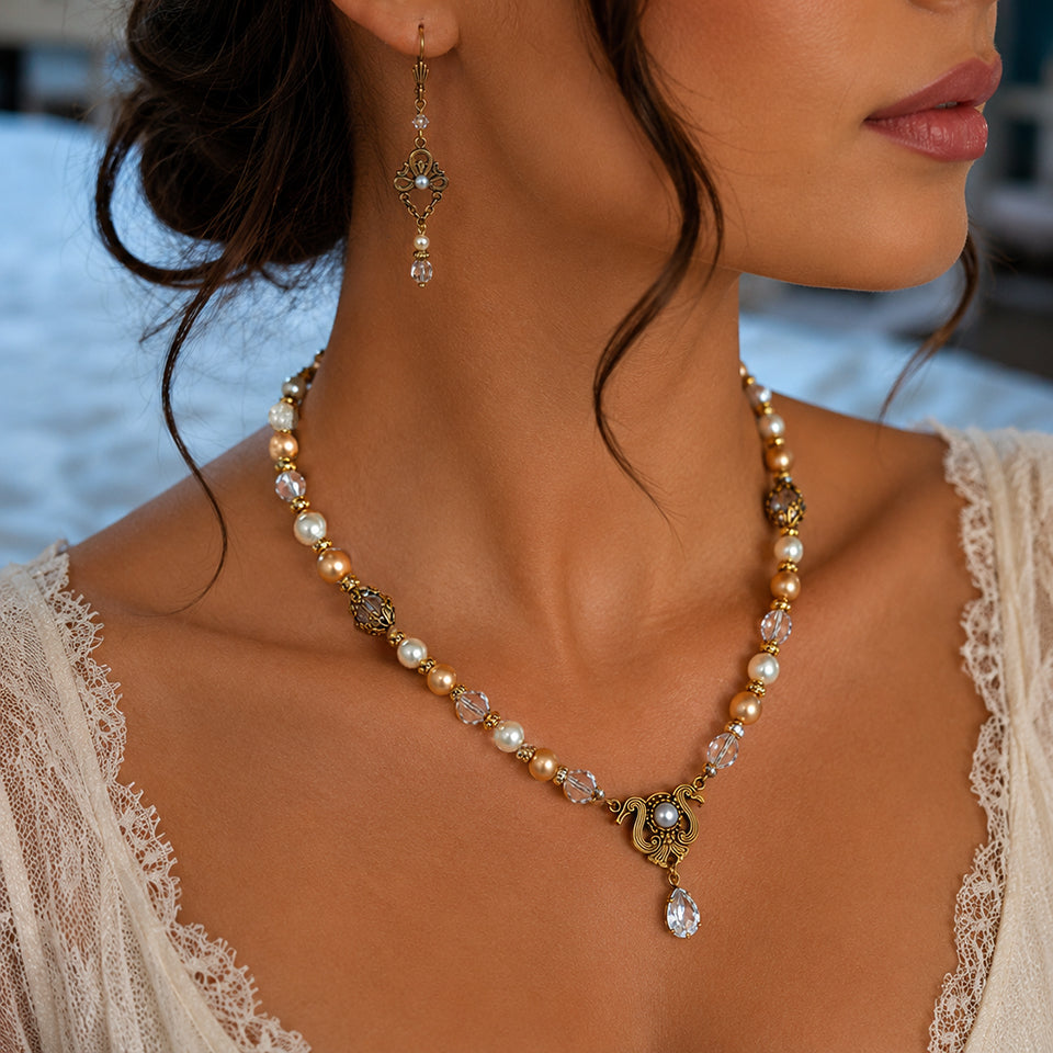 Close-up of a woman wearing a Vintage bridal Swarovski Crystal, Ivory and Gold Pearl necklace and earring with a blurred background