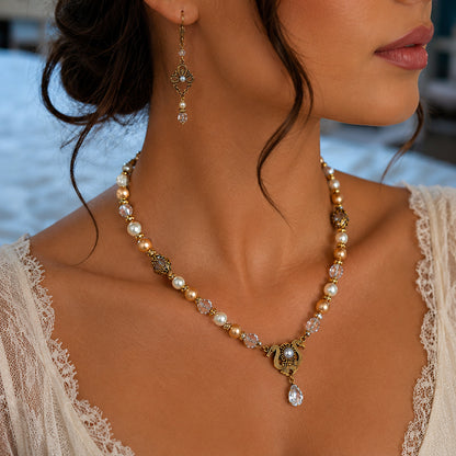 Close-up of a woman wearing a Vintage bridal Swarovski Crystal, Ivory and Gold Pearl necklace and earring with a blurred background