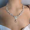 Pearl necklace with a silver clasp on a woman