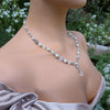 Pearl and crystal necklace on a woman with a blurred natural background