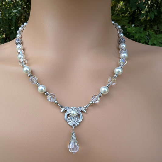 Pearl and crystal necklace on a woman with a blurred green background