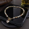 Elegant vintage style bridal Necklace with pearls and gold accents on a dark surface