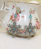 Sterling Silver Snowflake necklace and earring set made with aquamarine Swarovski crystals.